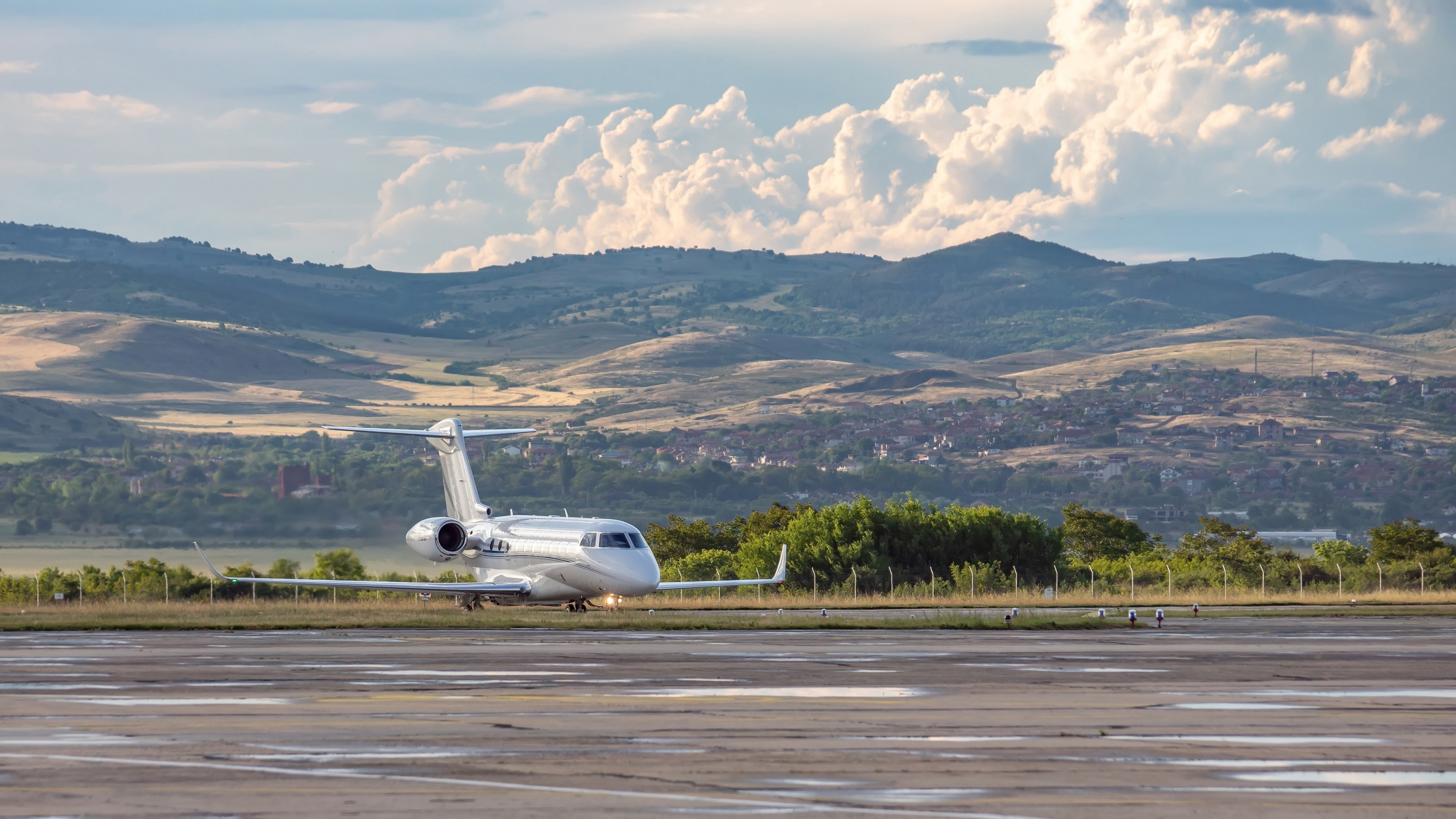 private jet taxiing on runway in the mountains during the summer months